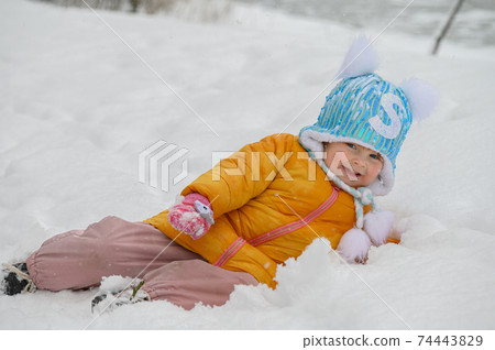 little cute girl playing in snow 74443829