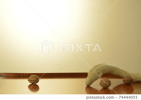 Decorate walnuts and driftwood. Mahogany table on a bright background. British antique furniture (soft focus) Decorate walnuts and driftwood. Mahogany table on a bright background. British antique furniture (soft focus) 74444055