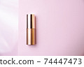 Golden beauty product on pink minimalist still life 74447473