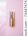 Golden beauty product on pink minimalist still life 74447474