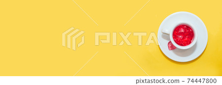 cup with hearts on a red background. the view from the top. red hearts spilled out. isolated on a pink background. copy space. panton 74447800