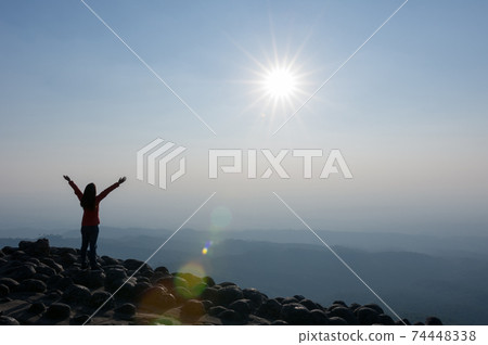 Woman on cliff of mountains. Woman on cliff of mountains. 74448338