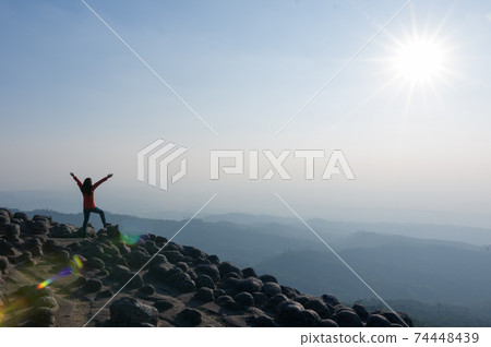 Woman on cliff of mountains. Woman on cliff of mountains. 74448439