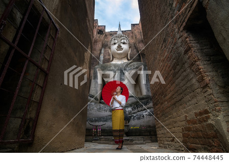 Thai traditional dress at Wat Si Chum. Thai traditional dress at Wat Si Chum. 74448445