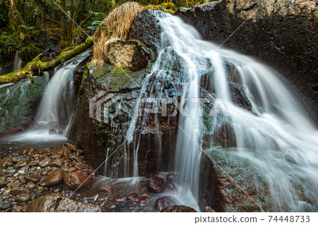 Scenery of a waterfall flowing down the clear stream Kikuchi Gorge in winter 74448733