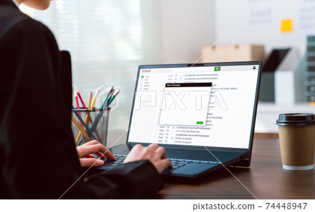 Businesswoman typing writing a message online email on laptop on the table at office. Businesswoman typing writing a message online email on laptop on the table at office. 74448947