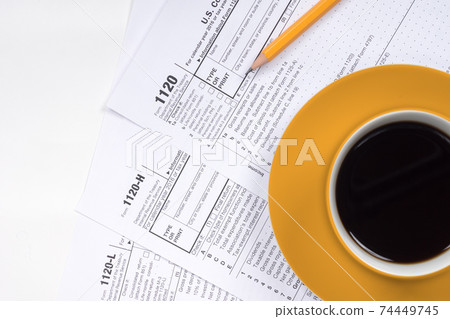 1120 tax forms top view with coffee cup and pencil 1120 tax forms top view with coffee cup and pencil 74449745