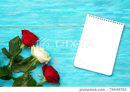red and white roses over blue wood table red and white roses over blue wood table 74449765