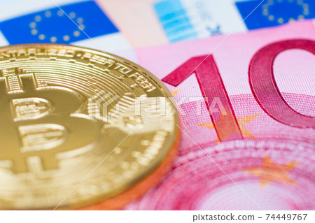 golden bitcoin metallic coin over euro banknotes, cryptocurrency golden bitcoin metallic coin over euro banknotes, cryptocurrency 74449767