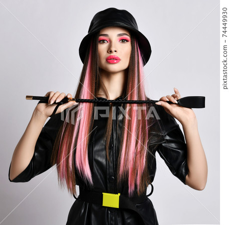 Woman with colored hair and pouty lips in leather 74449930