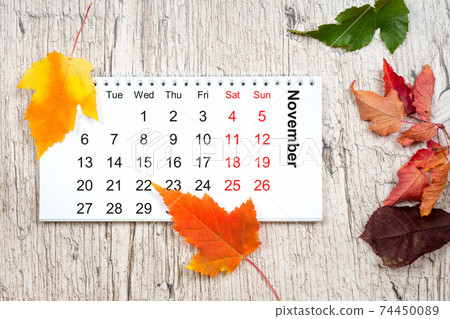 november paper calendar on wooden textured table with colorful a november paper calendar on wooden textured table with colorful a 74450089