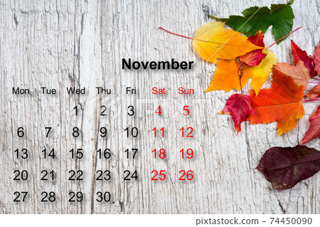 november calendar on wooden textured table with colorful autumn 74450090