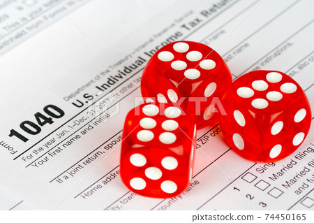 individual income tax return form 1040 with three red dices 74450165