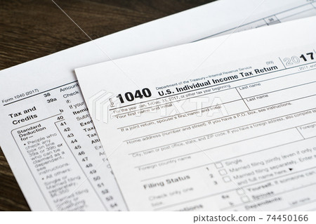 1040 form with tax and credits section, closeup shot 74450166