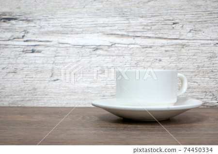 white coffee or tea cup on wooden table 74450334