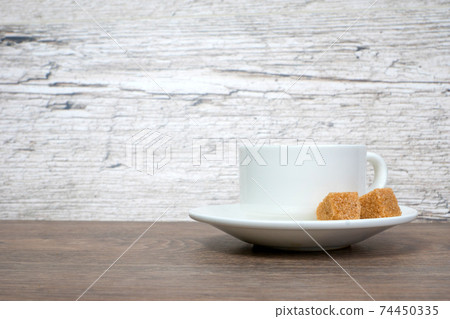white coffee or tea cup with brown cane sugar on wooden table white coffee or tea cup with brown cane sugar on wooden table 74450335