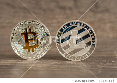 silver bitcoin and litecoin mettallic coins on wooden table silver bitcoin and litecoin mettallic coins on wooden table 74450341