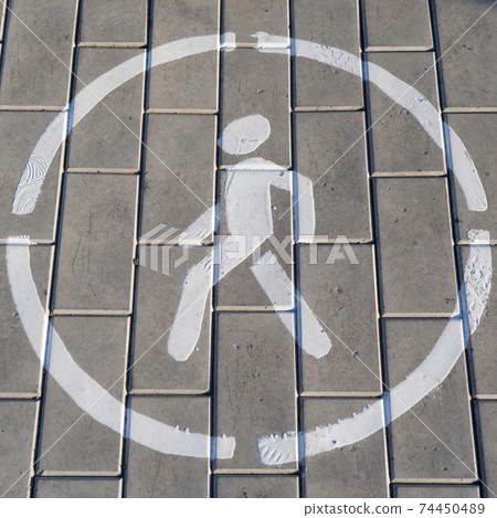 white pedestrian road sign painted on asphalt white pedestrian road sign painted on asphalt 74450489