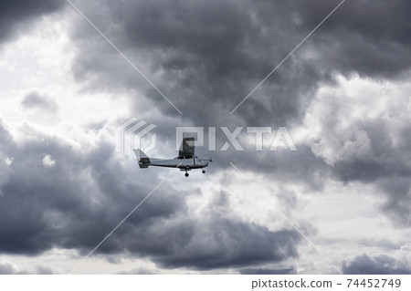 A private plane in the sky. One engine small passenger aircraft taking off. 74452749