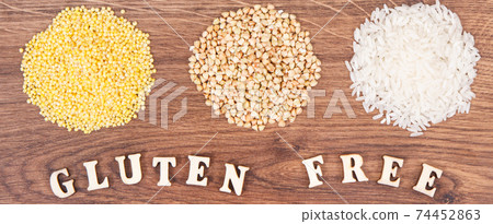Gluten free inscription and millet groats, white buckwheat, rice on rustic board 74452863