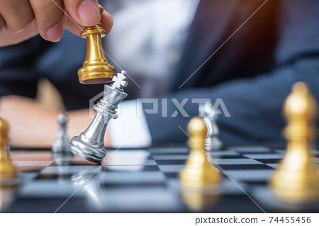 businessman hand moving gold Chess King figure and Checkmate opponent during chessboard competition. Strategy, Success, management, business planning, disruption and leadership concept businessman hand moving gold Chess King figure and Checkmate opponent during chessboard competition. Strategy, Success, management, business planning, disruption and leadership concept 74455456