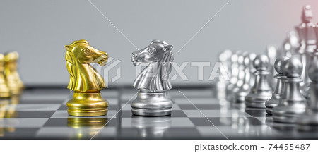 Gold and silver Chess Knight (horse) figure on Chessboard against opponent or enemy. Strategy, Conflict, management, business planning, tactic, politic, communication and leader concept Gold and silver Chess Knight (horse) figure on Chessboard against opponent or enemy. Strategy, Conflict, management, business planning, tactic, politic, communication and leader concept 74455487