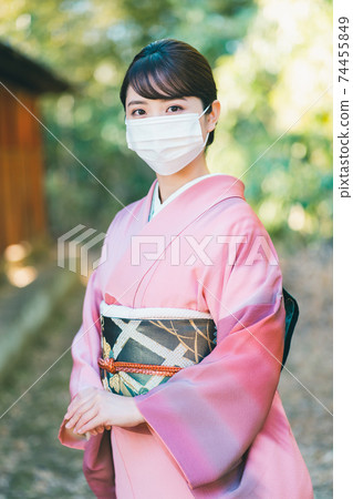 A woman in her twenties wearing a kimono and a mask A woman in her twenties wearing a kimono and a mask 74455849