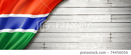 Gambian flag on old white wall banner 74456056
