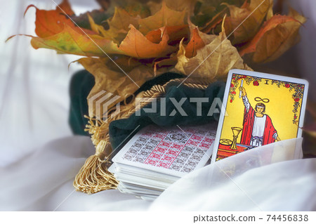 Blurred Tarot reading, card magician on the table. Esoteric 74456838