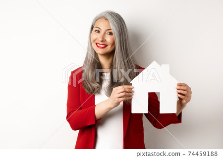 Smiling real estate agent showing paper house clipboard, broker working with client, standing over white background Smiling real estate agent showing paper house clipboard, broker working with client, standing over white background 74459188