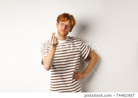 Image of satisfied young man with red hair and glasses showing chefs kiss gesture to praise something perfect, standing over white background Image of satisfied young man with red hair and glasses showing chefs kiss gesture to praise something perfect, standing over white background 74462987