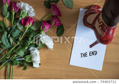 Paper with word break up on a floor with withered flowers. Heart broken. Divorce 74463712