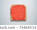 spreading red paste on a toast on white Background. Top view 74464514
