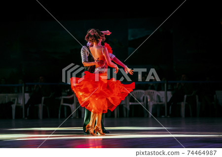 couple dancers dancing in dark gym 74464987