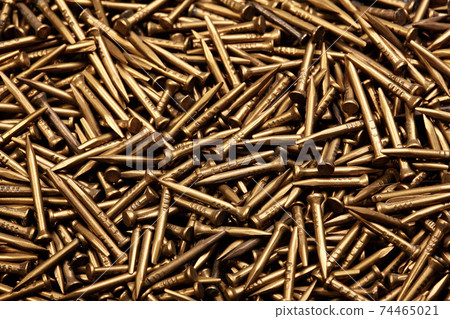 Close up texture of nails.Brass shoe nails 74465021