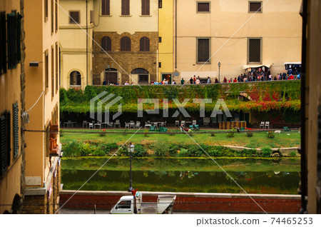 View of the embankment near the Ponte Vecchio bridge on the Arno river in Florence - Italy 74465253