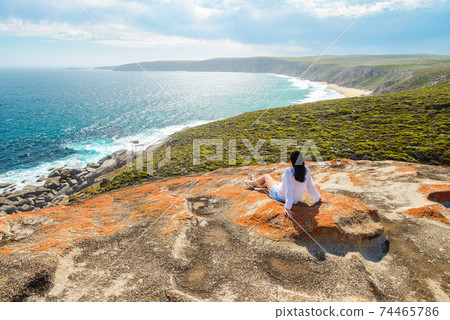 Woman sitting on the edge of the cliff , Kangaroo Island, South Australia Woman sitting on the edge of the cliff , Kangaroo Island, South Australia 74465786