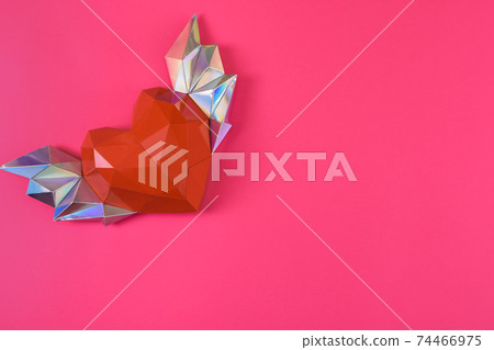 Red polygonal paper heart with wings on a pink background. Top view 74466975