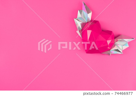 polygonal paper heart with wings on a pink background. 74466977