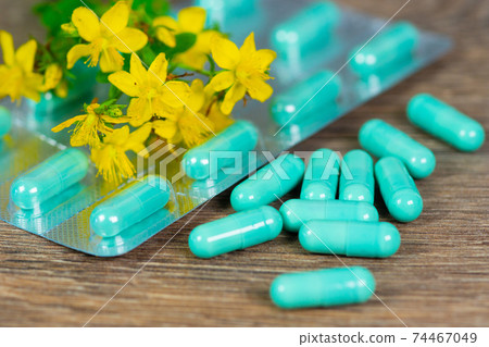 herbal pills with blister and yellow herb flowers herbal pills with blister and yellow herb flowers 74467049