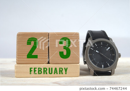 23 february calendar date on wooden blocks with wrist watch 74467244