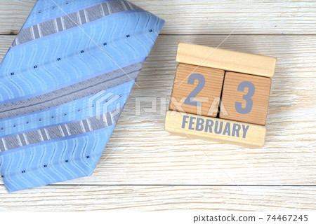 23 february calendar date on wooden blocks with blue neck tie 74467245