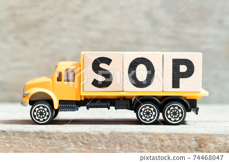 Toy truck hold alphabet letter block in word SOP (Abbreviation Standard Operating Procedure) on wood background Toy truck hold alphabet letter block in word SOP (Abbreviation Standard Operating Procedure) on wood background 74468047