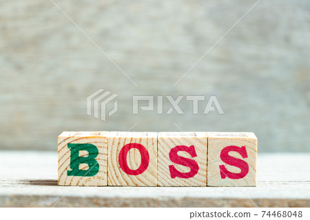 Alphabet letter block in word boss on wood background Alphabet letter block in word boss on wood background 74468048