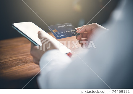 Close up of women's hand using cellphone or mobile for shopping online or payment with credit card.Shopping online concept. 74469151