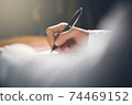 People writing on notebook and work with paper on wooden table. 74469152