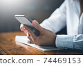 Close up of women's hand using cellphone or mobile for search website,data,social network with comunication.Business and finance concept. 74469153