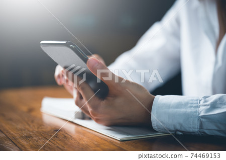 Close up of women's hand using cellphone or mobile for search website,data,social network with comunication.Business and finance concept. 74469153