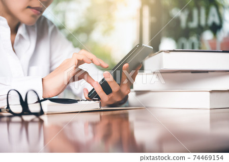 Close up of women's hand using cellphone or mobile for search website,data,social network with comunication.Business and finance concept. 74469154