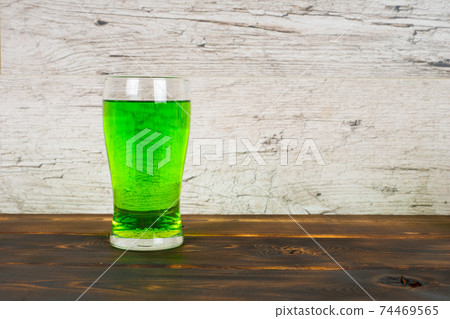 green beer in glass on pub table 74469565